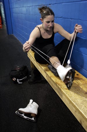 Stephanie Roth unlaces her skates after practice at Wall Sports Arena in 2006