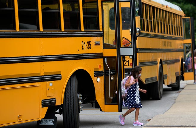 A Edmondson Elementary School student exits the bus a she walks to class during the first day of school at Edmondson Elementary School on Friday, August 6, 2021 in Brentwood, Tenn. 