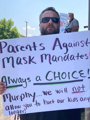 A parent protests against New Jersey Governor Phil Murphy’s announcement on Friday that a mask mandate will be imposed in K-12 schools this fall.