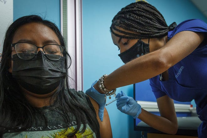 Genesis Pablo, 16, Palm Springs, receives a shot from medical assistant supervisor Bianca Lantigua, Boynton Beach, during a COVID-19 vaccination event at the FoundCare PEDS North offices in West Palm Beach, Fla., on Saturday, July 31, 2021.