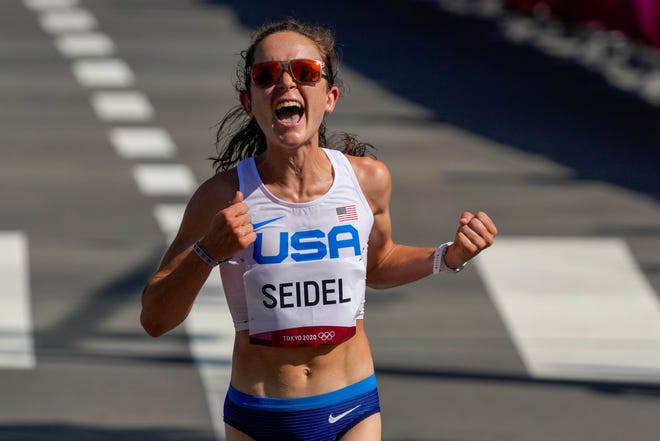 Molly Seidel, of the United States, celebrates as she crosses the finish line to win the bronze medal in the women's marathon at the 2020 Summer Olympics, Saturday, Aug. 7, 2021, in Sapporo, Japan (AP Photo/Shuji Kajiyama).