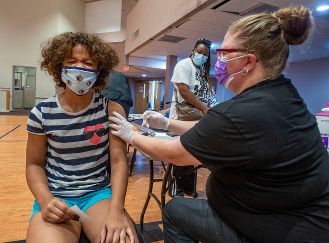 Donna Clegg,14, receives her COVID-19 vaccine Saturday at the "Back-to-School Vax and Dash" at the Brownsville Community Center.