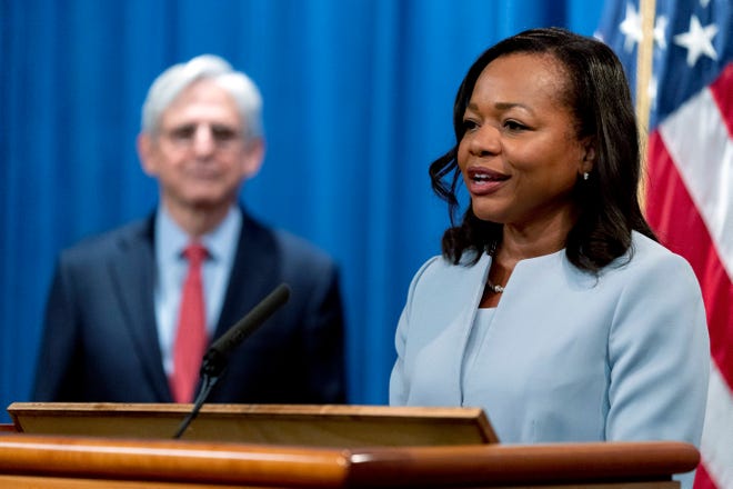 Assistant Attorney General for Civil Rights Kristen Clarke, right, accompanied by Attorney General Merrick Garland, left, speaks at a news conference at the Department of Justice in Washington on Aug. 5, 2021. The DOJ on Thursday announced an agreement with Evolve Bank & Trust on Thursday to resolve allegations of lending discrimination.