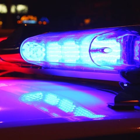 A close-up photo of police lights by night