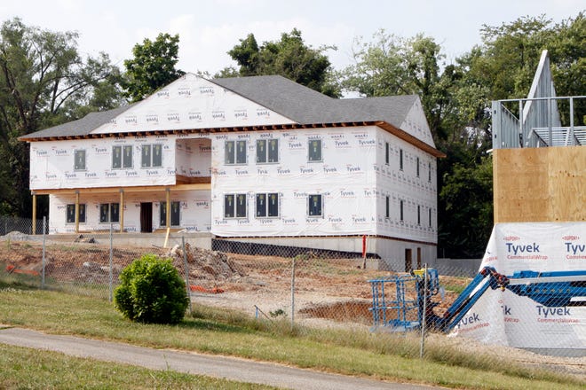 New Hope for Families' new facilities are seen Saturday along West Patterson Drive at South Morton Street. The building at left will provide housing for families, while the one partially visible at right will be used for early childhood education.