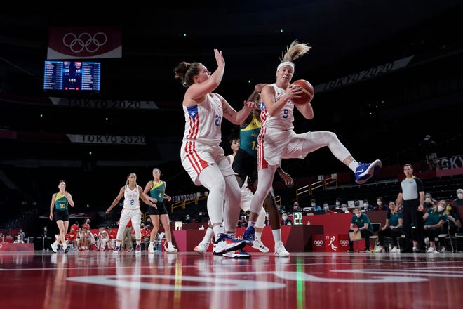 Puerto Rico's Ali Gibson (9) pulls down a rebound in front of Australia's Ezi Magbegor (13) during a women's basketball game at the 2020 Summer Olympics, Aug. 2, 2021, in Saitama, Japan.