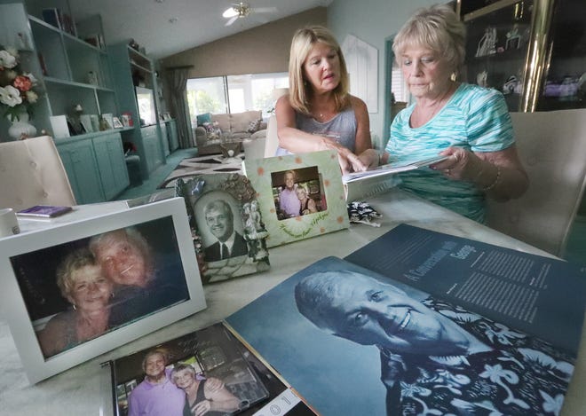 Coleen Donaldson and mom Joyce Mirabal look over a photo album, some old family photographs and a old magazine article of her dad George Mirabal, at her parents' Port Orange home on Monday, Aug. 9, 2021.