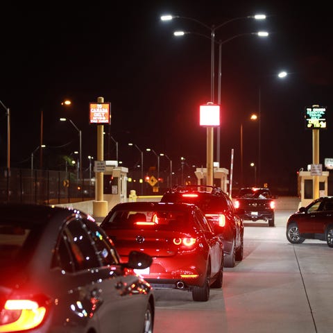 Vehicles wait at the toll booth in Detroit before 