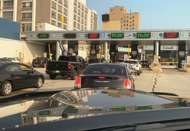 Cars line-up to enter Canada from the Detroit Windsor Tunnel after crossing the border from Detroit into Windsor on Aug. 9, 2021, the first full day of the border re-opening after it had been closed down due to the pandemic.