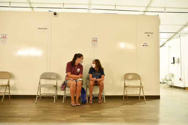 ErinSeifert, of Waldwick, sits with her 12 year old daughter, Maggie, after she received her first shot of the Pfizer vaccine at Bergen New Bridge Medical Center in Paramus, N.J. on Monday Aug. 9, 2021. Students who are vaccinated by August 9th with the Pfizer vaccine will be able to get their second dose on August 30th and be fully vaccinated by September 13th for the start of school.