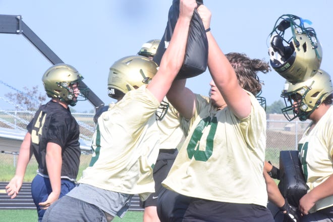 Sawyer Huntimer loses his helmet in a drill during the first day of high school football practice on Aug. 9, 2021.