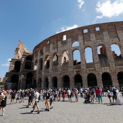 Tourists wait in line to enter the Colosseum in Ro