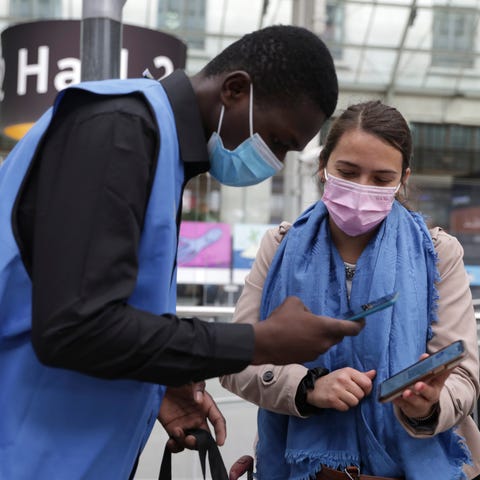 A railway employee checks the COVID-19 health pass