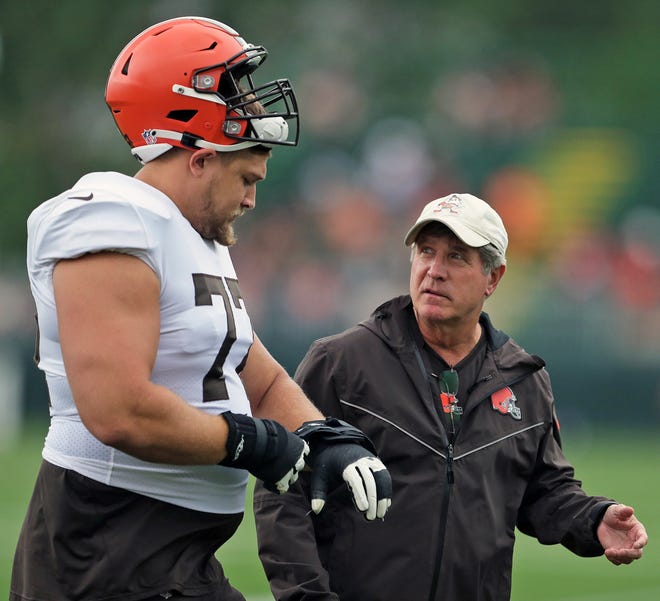 Cleveland Browns offensive guard Wyatt Teller (77) speaks with offensive line coach Bill Callahan during NFL football practice, Tuesday, Aug. 10, 2021, in Berea, Ohio.