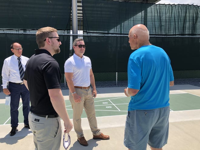 Holly Hill City Manager Joe Forte, Mayor Chris Via and U.S. Rep. Michael Waltz, from left to right, listen to Pictona founder Rainer Martens as he leads the group on a tour of the recreational complex on Tuesday, Aug. 10, 2021.