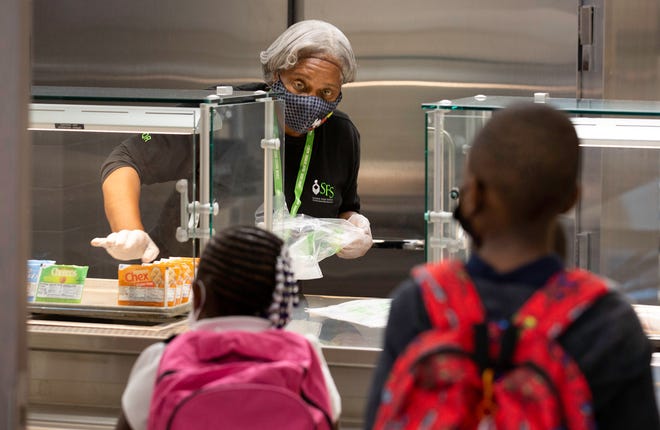 Brenda Bartee serves up breakfast to students at Washington Elementary School in Riviera Beach on the first day of the school in 2021.