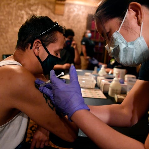 Paul Hinojosa receives a COVID vaccine after Tuesd