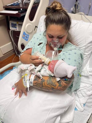 West Melbourne resident Kristen McMullen holds her newborn daughter, Summer Reign, after an emergency C-section on July 27 at Holmes Regional Medical Center in Melbourne. McMullen died of COVID-19 on Aug. 6.