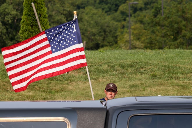 People gathered on both sides of Thomas More Parkway by St. Elizabeth Edgewood Hospital in Edgewood, Ky on Tuesday, August 10, 2021 to protest St. Elizabeth’s newly announced COVID-19 vaccine requirement. The hospital and other medical centers have announced mandatory vaccination for all healthcare workers they employ.