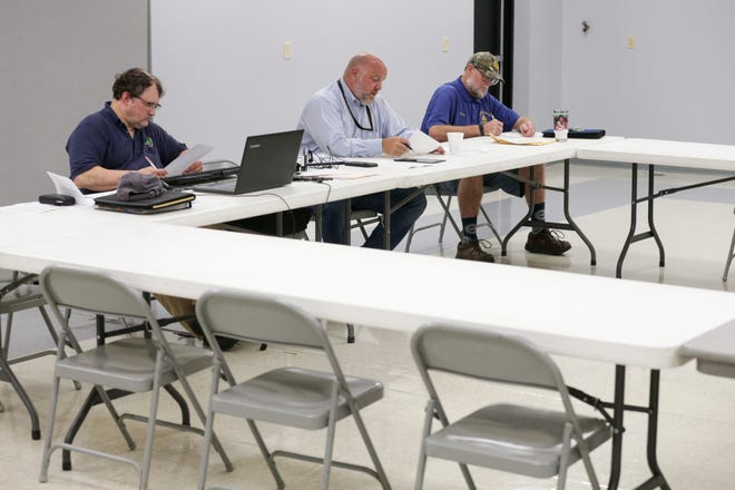 Fairfield board members, from left, Rocky Hession, Stephen Snyder and Perry Schnarr sit inside an all but empty room at the Plumbers & Pipefitters Local Union 157 hall during a meeting of township board, Tuesday, Aug. 10, 2021 in Lafayette.