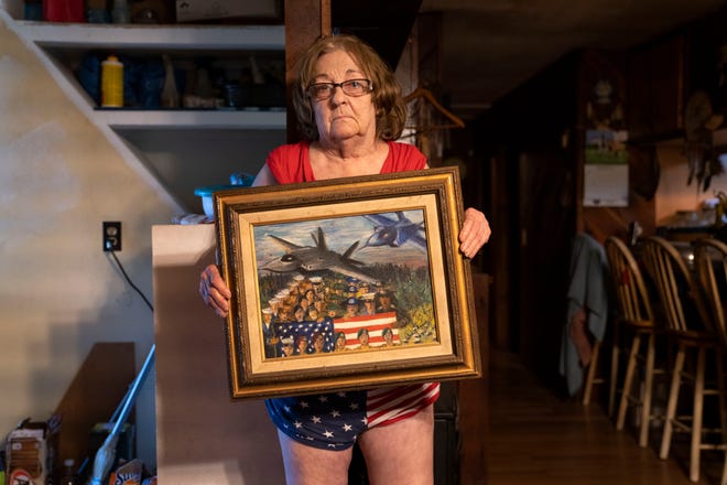 Judy Ansell holds one of her paintings at her home in Stonycreek Township, Pennsylvania, on Wednesday, August 4, 2021.