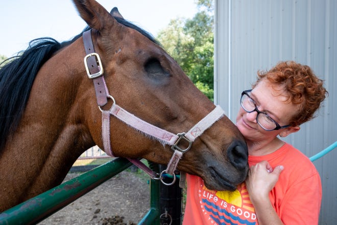 Jennifer Hubbell nuzzles with Teeticket, an 8-year-old mare rescued by Beyond The Roses Equine Rescue Monday, Aug. 9, 2021, in Emmett.