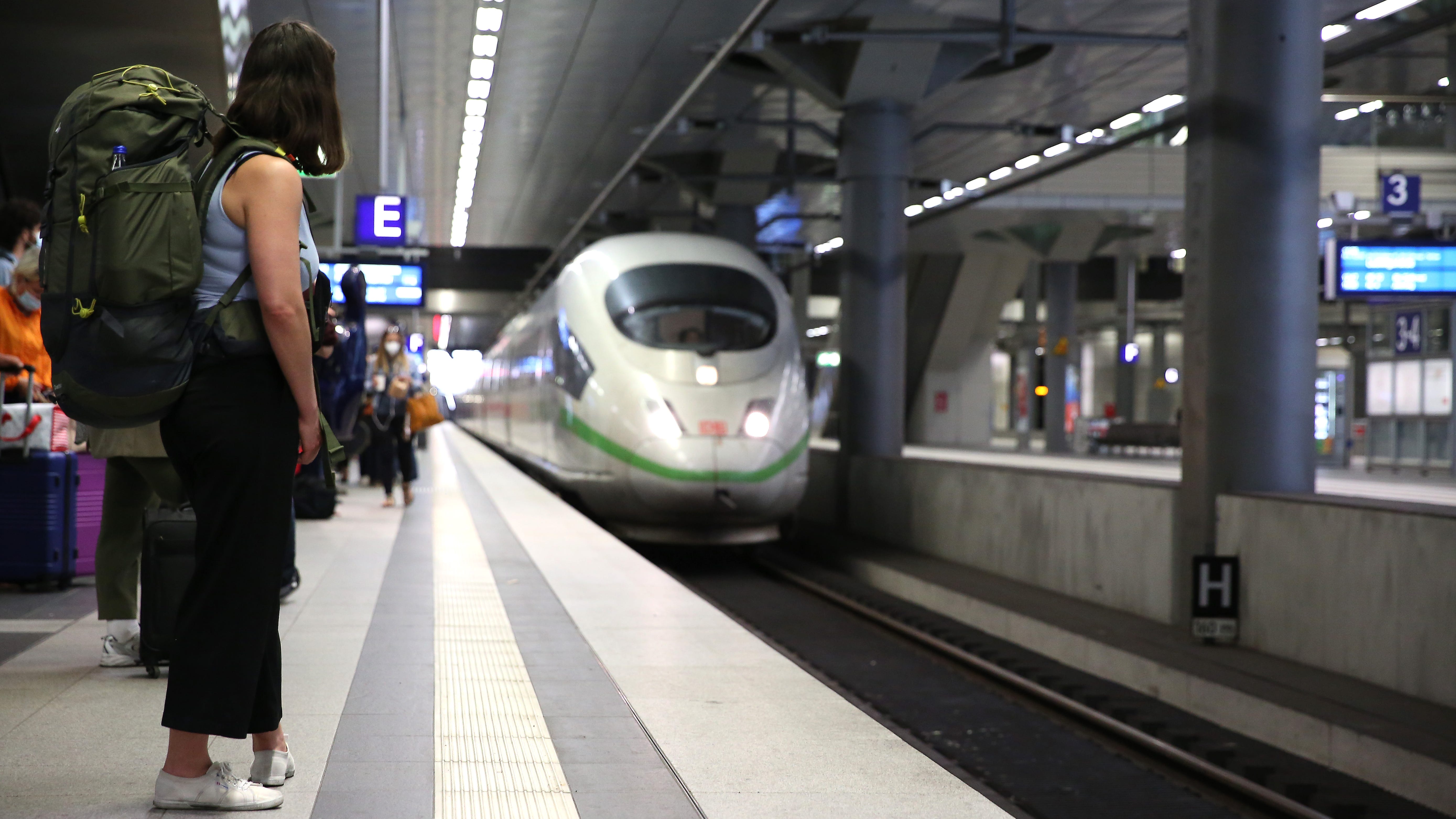 A passenger looks on as a high-speed train approaches at Berlin's main train station on August 10, 2021. Starting Sunday, unvaccinated travelers to Germany who have been in the U.S. recently will need to quarantine at least five days.