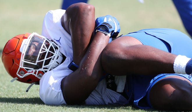 UF defensive end Zachary Carter recovers a fumble during a drill Monday at the Gators' practice field.