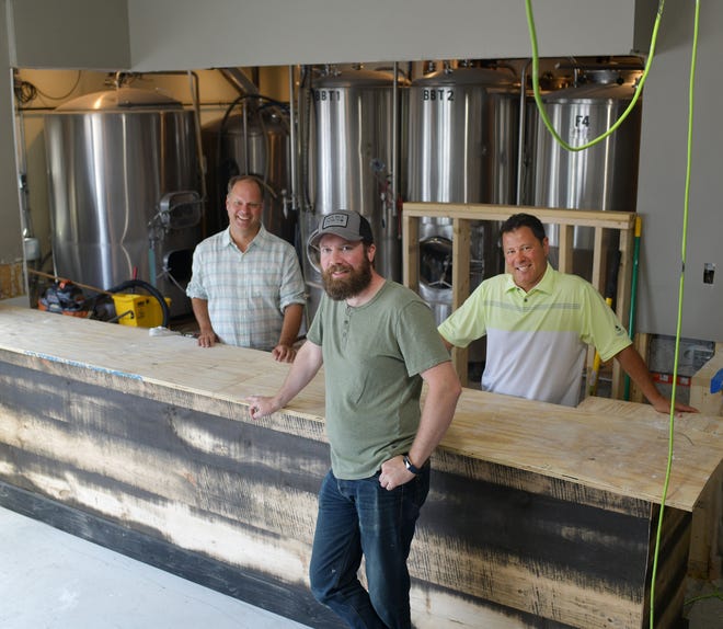 Christian McMahan, brewer Brian Wells and Tom Oliveri are pictured last August in the space that would become Double Down Brewing Company.