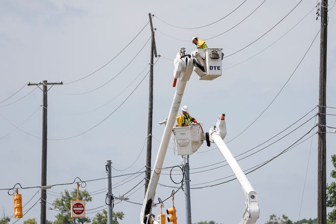 A DTE crew works on power lines on Michigan Avenue near I-275 in Canton Township on August 12, 2021.