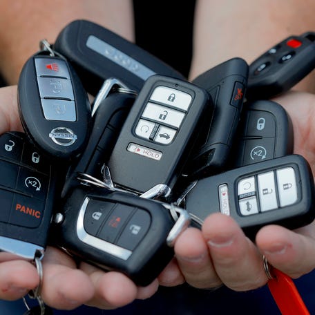 Eleven key fobs of the cars Bill Huffhine is holding at a parking lot in Troy on August 10, 2021. Huffhine started using the popular app as a side business in late 2017 and at one point had 20 cars in his fleet to rent out. More people are using Turo as an alternative to the big car rental agencies.