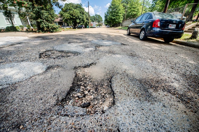 Potholes can be seen near the intersection of North Congress and Barksdale Streets in Jackson on Thursday, Aug. 12, 2021.
