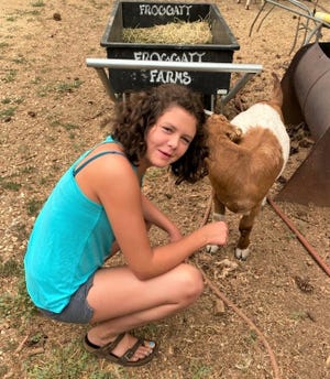 Kadee McKinney, 12, is reunited with her goat after the Dixie Fire burned through Greenville.