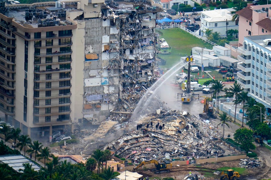 Rescue personnel work at the remains of the Champlain Towers South condo building in Surfside, Fla., on June 25.