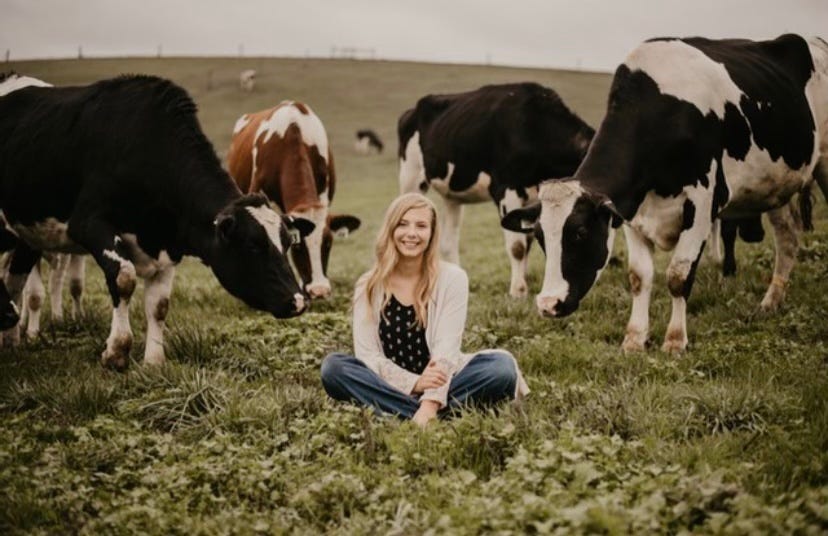 Pennsylvania Dairy Princess alternate Katerina Coffman poses with cows from her family farm.