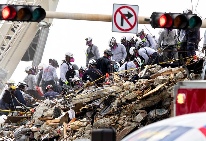Searchers dig through the rubble at the base of Champlain Towers South condo in Surfside, Florida Tuesday, June 29, 2021. The condominium partially collapsed Thursday, June 24. (Lannis Waters/The Palm Beach Post/TNS)