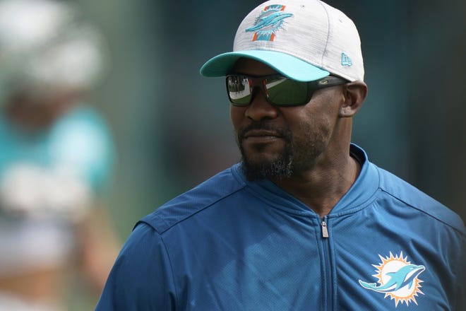 Miami Dolphins head coach Brian Flores walks onto the field during practice at the NFL football team's training facility, Wednesday, Aug. 4, 2021, in Miami Gardens, Fla. (AP Photo/Wilfredo Lee)