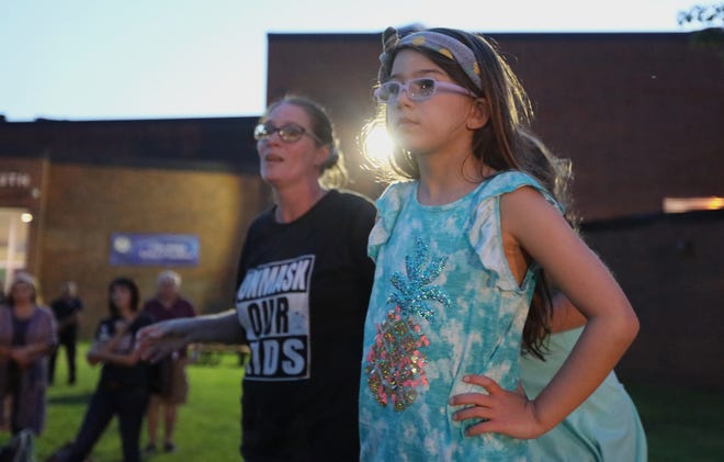 Karalyn Maggino, with her daughter, Madison, 8, speaks outside of Clarkstown South in West Nyack after a Clarkstown School Board meeting was adjourned early when many attendees refused to wear masks Aug. 12, 2021.