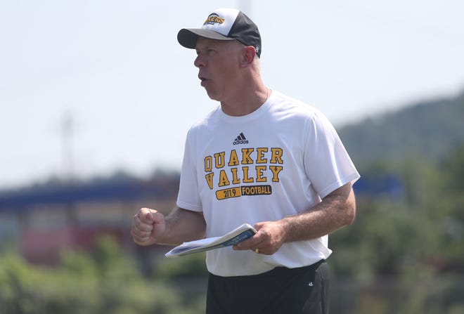 Quaker Valley Head Coach Ron Balog calls a play to his offensive line during training camp Friday afternoon at Quaker Valley High School. 