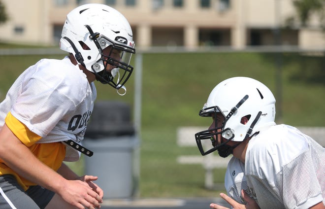 Quaker Valley's John Weaver (right) and Tommaso Floro (left) go head to head during blocking drills during training camp Friday afternoon at Quaker Valley High School.