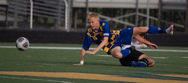 Wooster's Aiden Strand-Fox is fouled while in pursuit a ball at midfield.