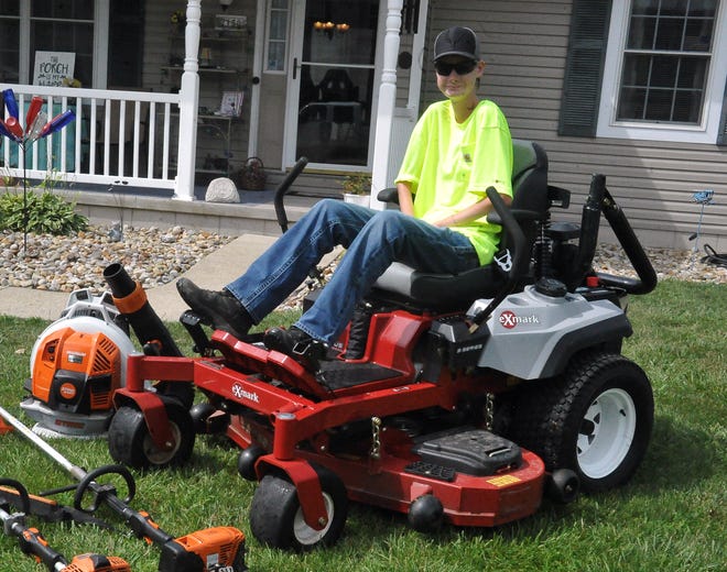 Cooper Meshew with his lawn mowing equipment he uses for his lawn care service called Cooper's Mowing Service. He uses a riding mower because it is easier for him to use rather than other kinds of mowers due to his medical condition and physical limitations.