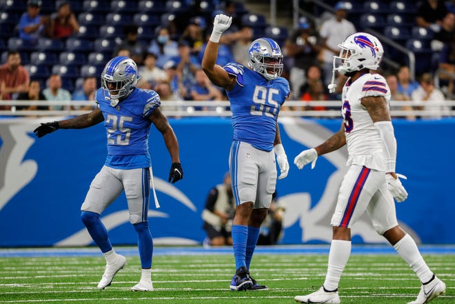 Detroit Lions defensive end Romeo Okwara (95) and defensive back Will Harris (25) celebrate a play against the Buffalo Bills during the second half of the preseason game at Ford Field in Detroit on Friday, Aug. 13, 2021.