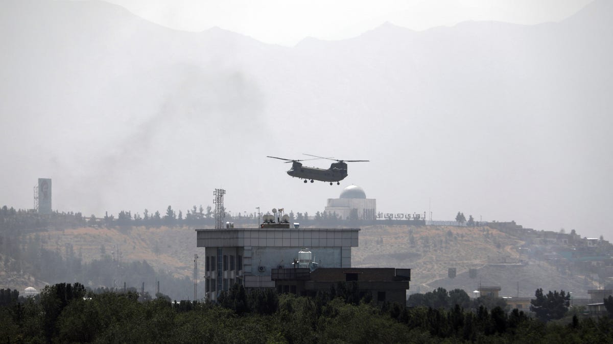 A U.S. Chinook helicopter flies over the U.S. Embassy in Kabul, Afghanistan, Sunday, Aug. 15, 2021.