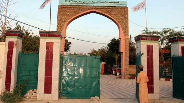 Taliban flags fly over the gate of the Ghazni prov