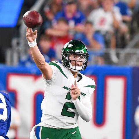 New York Jets quarterback Zach Wilson throws durin