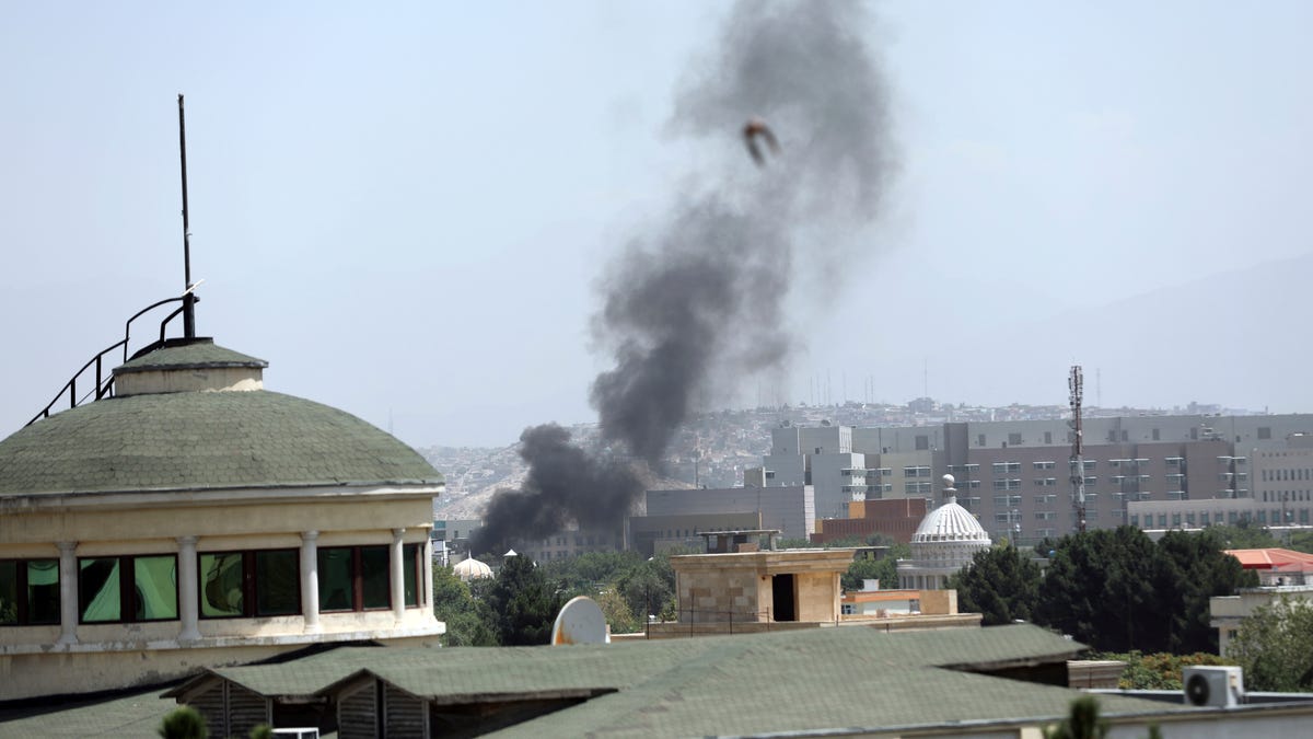Smoke rises next to the U.S. Embassy in Kabul, Afghanistan, Sunday, Aug. 15, 2021. Taliban fighters entered the outskirts of the Afghan capital on Sunday, further tightening their grip on the country as panicked workers fled government offices and helicopters landed at the embassy.