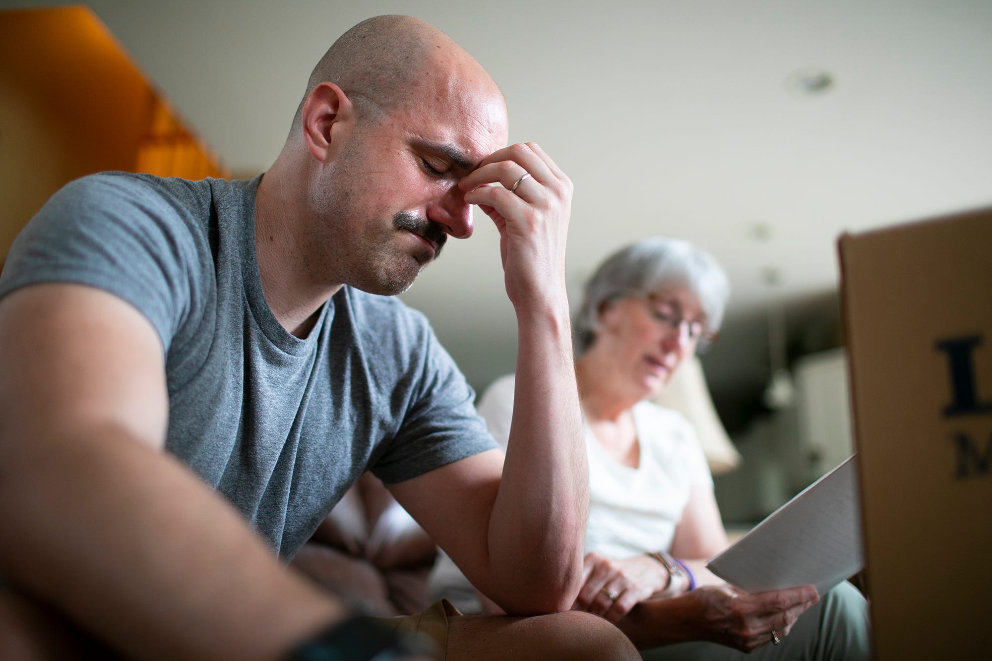 Chris Graham cries as his mother, Lynne, reads an essay that he wrote about his faith while in college. Graham was emotional because he didn't remember his 1997 rape by the Rev. Raymond Lavelle at the time he wrote it.