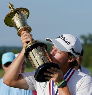 James Piot kisses the trophy after defeating Austin Greaser to win the U.S. Amateur.