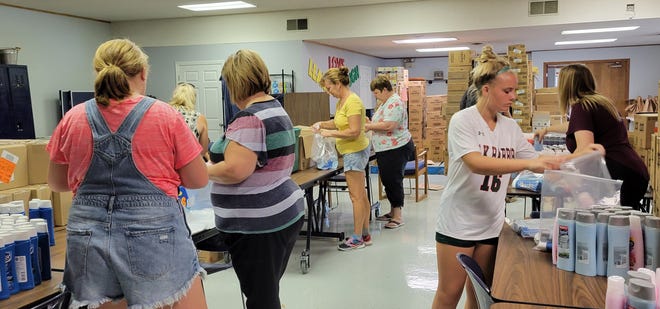 Volunteers for the Ottawa County Advocacy Center pack hygiene kits.